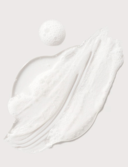 Smear of white, foamy texture with a bubble, likely a skincare or cosmetic product