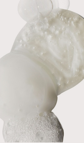 Close-up of a clear hair gel with bubbles, squeezed from a tube, suitable for spa services